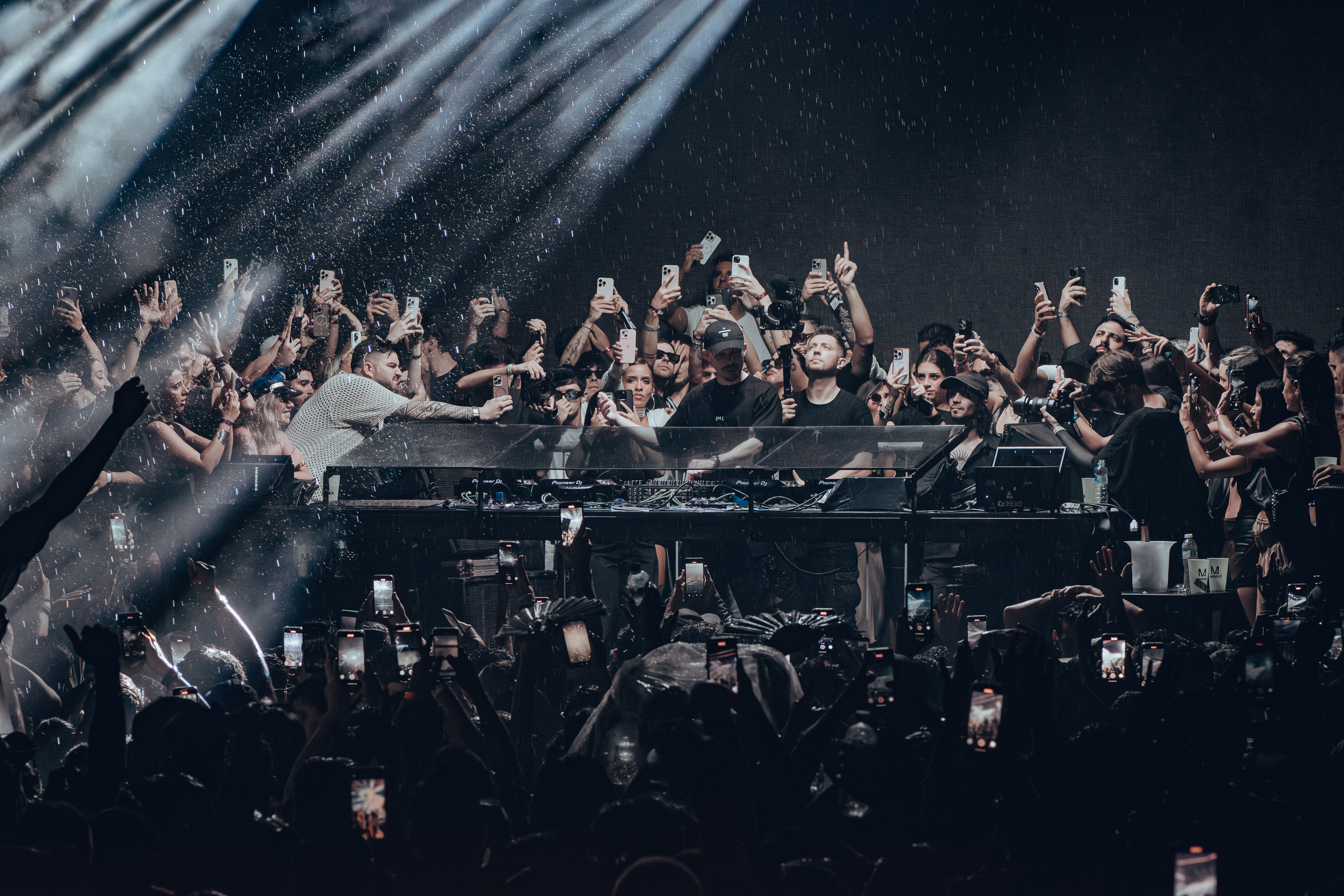 Massano performing at the decks surrounded by a crowd, from his official website